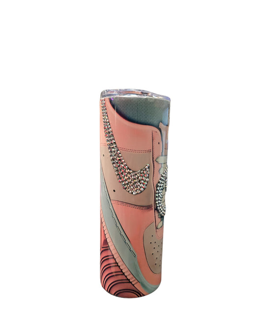 Introducing the 20oz Stainless Steel Rhinestone Tumbler Nike Inspired by Just For Lookz, featuring an artistic design that replicates a Nike Air Jordan shoe. With a striking pink and teal color scheme adorned with rhinestones forming the brand's logo and details, this tumbler is showcased against a plain white background.