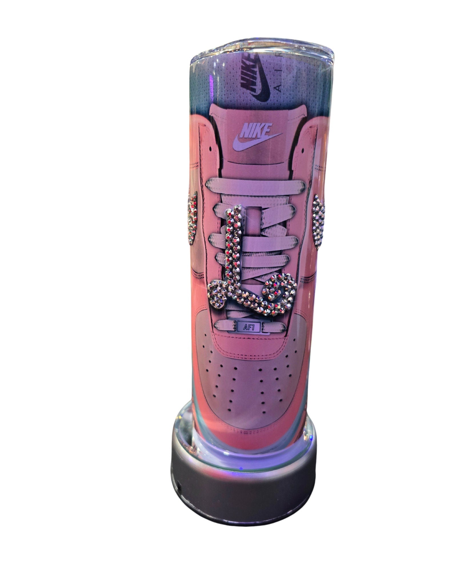 A creative tumbler designed to resemble a 20oz stainless steel Nike Air Force 1 sneaker, adorned with colorful sprinkles and rhinestone decorations. This Nike-inspired tumbler by Just For Lookz features intricate details, including laces and the Nike logo, making it appear very realistic.